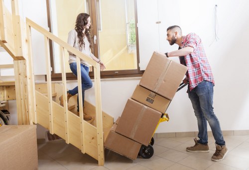 Removal workers handling boxes and furniture for a local move