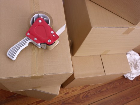 Careful wrapping of fragile household items for a move in Redbridge