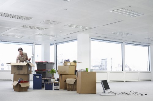 Professional movers handling boxes and furniture in a Redbridge street
